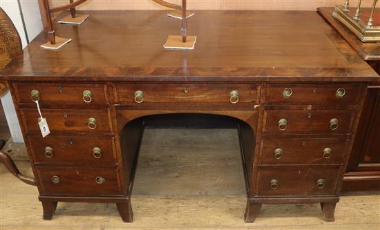 A mahogany kneehole desk W.138cm